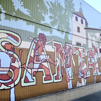 A mural of Santa Clara in big letters with a picture of Mission Santa Clara de Asís