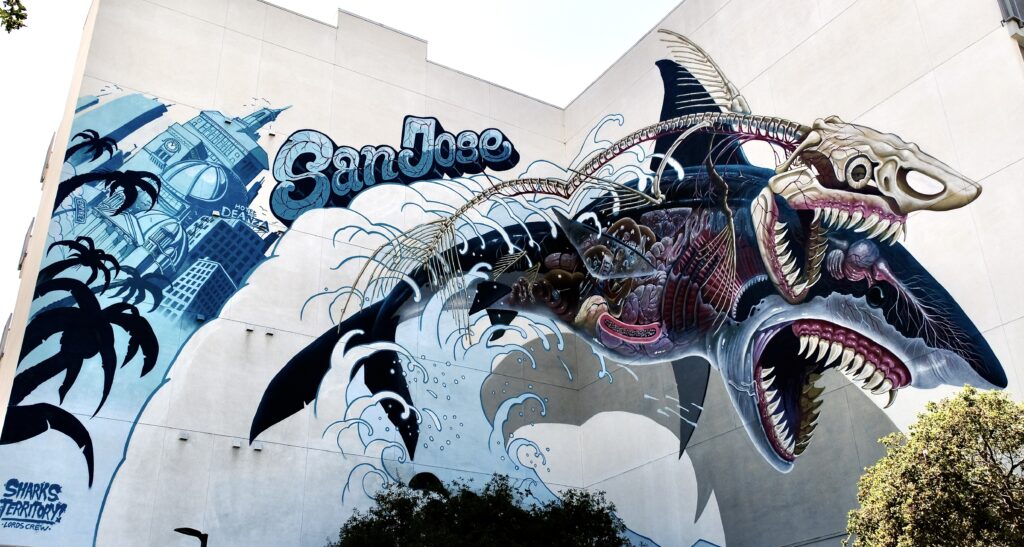 Mural of a shark by illustrator, Nychos, for the San Jose Sharks on display in the Whole Foods parking lot on the Alameda.