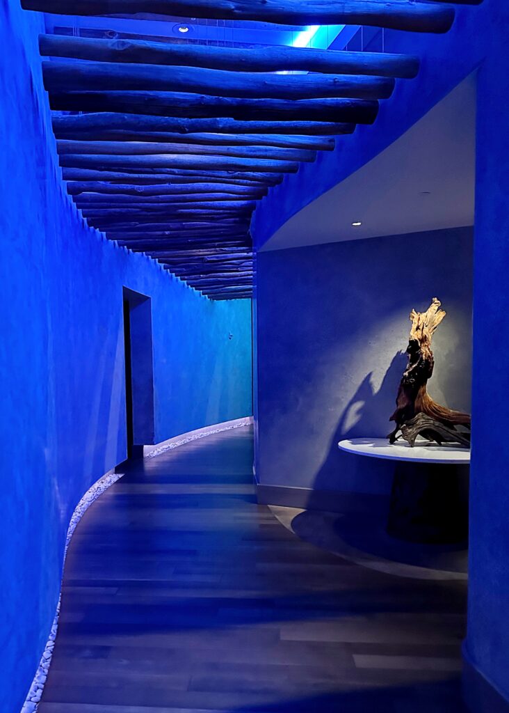 Hallway illuminated with a calming blue light, creating a serene atmosphere.