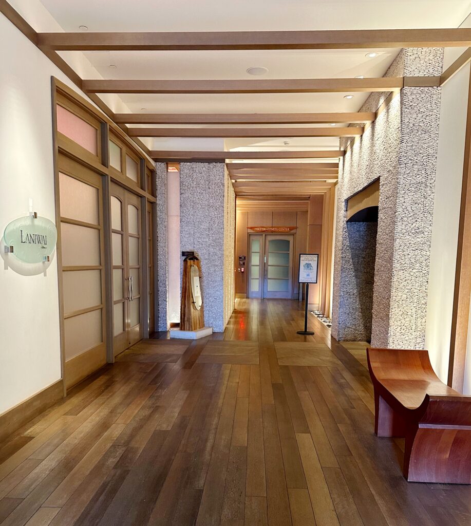 Hallway leading to the entrance of Laniwai featuring relaxing decor and ambient lighting.